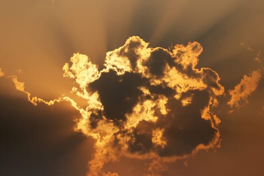 Evening sun behind clouds