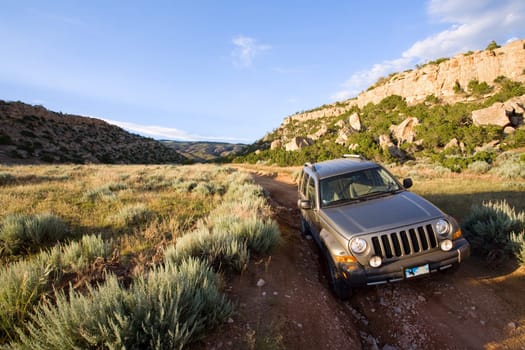 SUV on foot of mountain trail