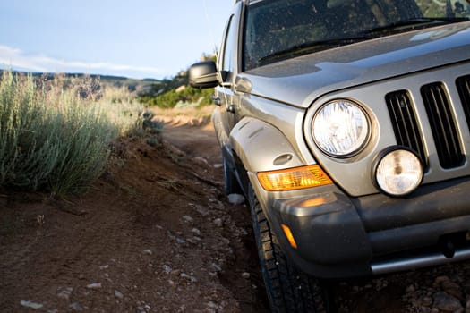 SUV on trail by mountains