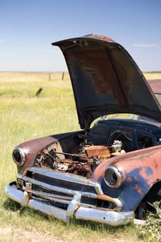 abandoned car in field