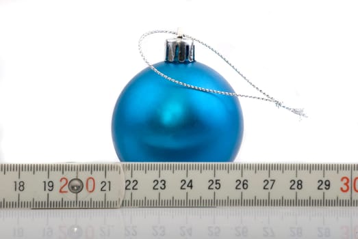 Chris tree ball in front of meter measure - symbolic image
