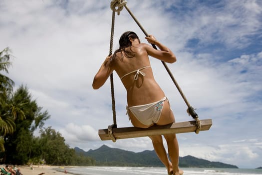 Girl on swing on the beach