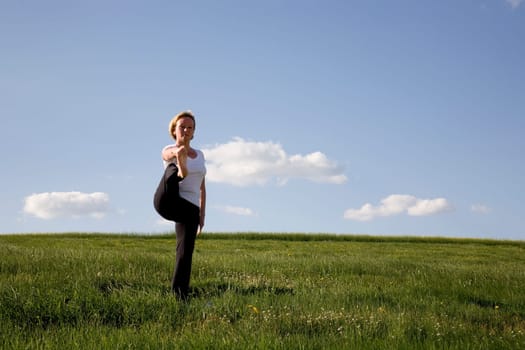 Woman doing yoga exercise - leg stretch