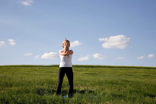 Woman doing yoga exercise - the eagle