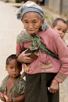 Asia,old woman with chicken and grandson