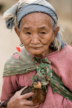 Asia,old woman with chicken