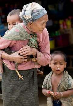 Asia,old woman with chicken and grandson