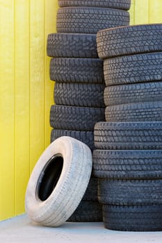 tires against yellow wall