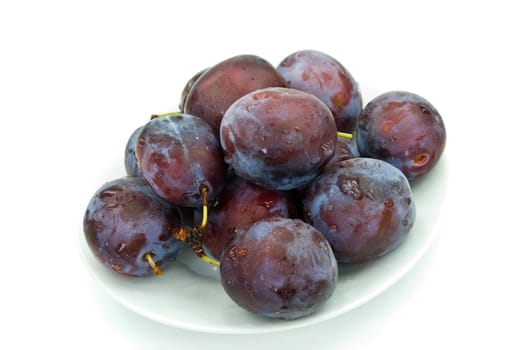 Fresh plums with drops of water