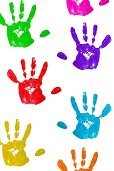 close up colorful child handprints on wh