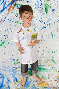 Little boy playing with painting