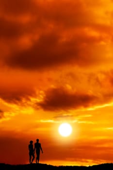 couple silhouetted by sunset