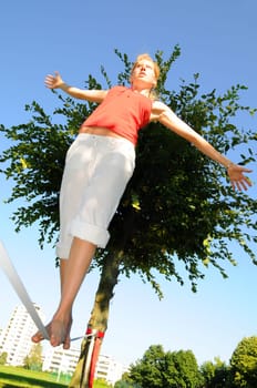 Woman walks on slackline