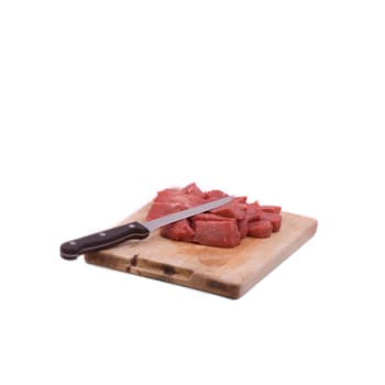 Beef tenderloin on wooden board with knife