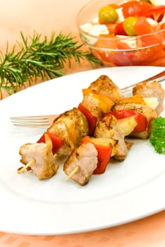 Meat skewer with salad