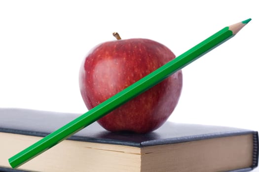 A red apple with green pencil on book