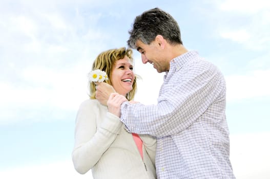 Mature romantic couple with flowers