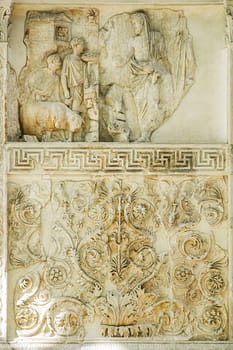 Rome, Italy, August 19, 2008: Ara Pacis. Altar of peace. Marble relief of Aeneas, flanked by two camili, sacrificing a white sow to the Penate gods