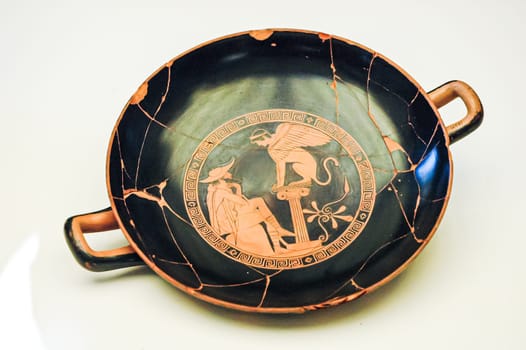 Rome, Italy, August 29, 2008: Attic red figured kylix. Oedipus, in wayfarers clothing, listens to the question asked him by the sphynx. Etruscan museum