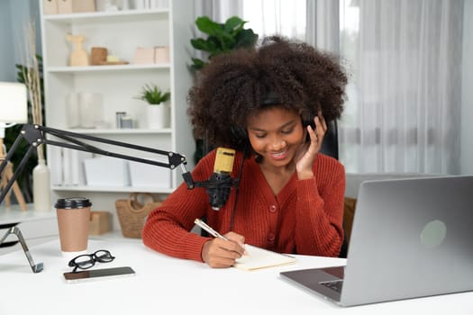 Host channel of beautiful African woman talking in online broadcast teaching marketing influencer, with listeners in broadcast or online. Concept of anywhere at work place. Tastemaker.