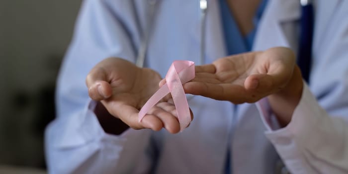 Pink October Breast Cancer Awareness month, doctor with pink ribbon symbol. National cancer survivors month. health care concept.