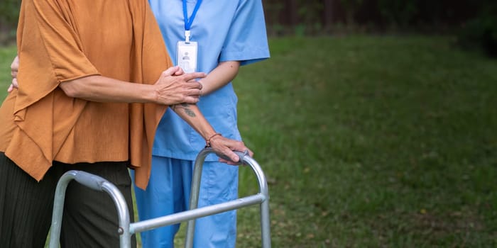 Nurse or caregiver hand on walking frame for support, help or trust moving leg in rehabilitation. Physiotherapy healthcare, Medical caregiver consulting disabled elderly patient at home.