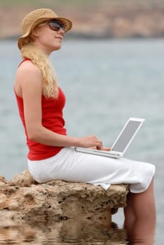 Woman with laptop on vacation