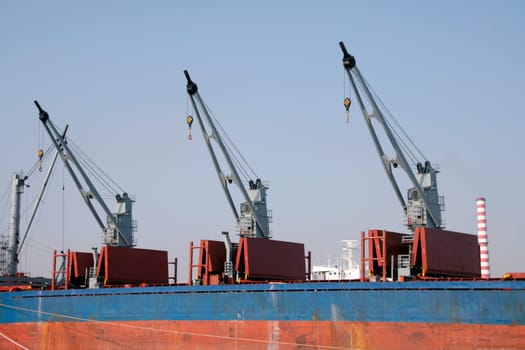 three cargo cranes