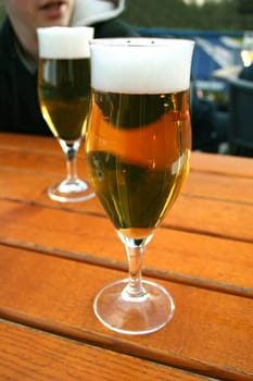 Two beer glasses on beer garden table