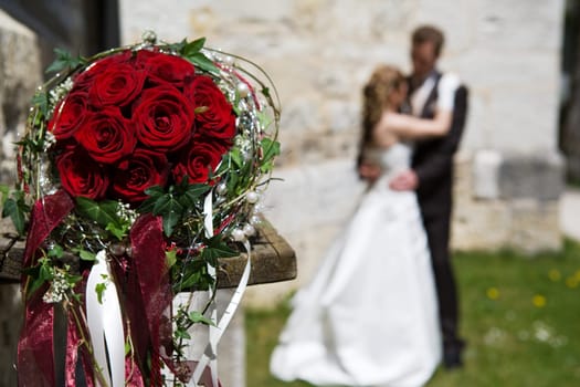 Bridal bouquet and bride and groom