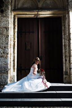 Bride in front of church gate