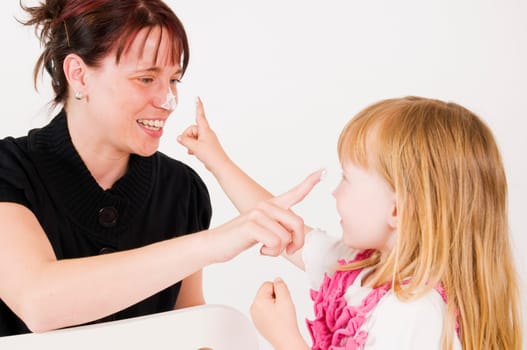 mother and daughter with cream