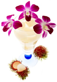 Rambutan with fruit juice and orchid