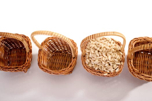wheat grain in a basket on white