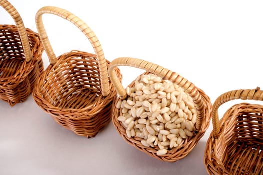 wheat grain in a basket on white