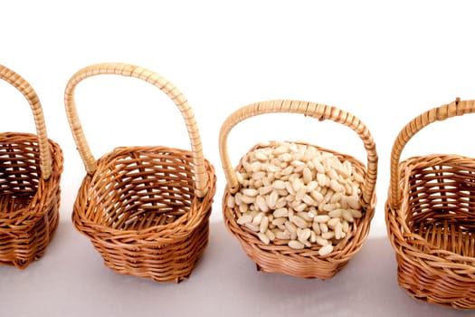 wheat grain in a basket on white
