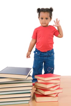 Baby standing with a pile of books
