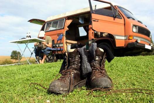 Hiking boots in front of camper van