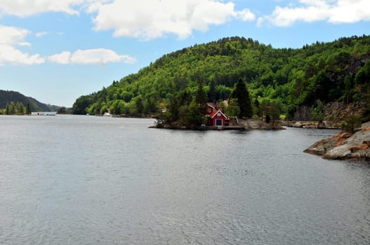 Typical Norway. Little red houses,mountains,fjords and roads with power lines.