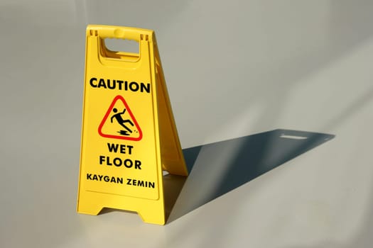 An image of yellow wet floor caution