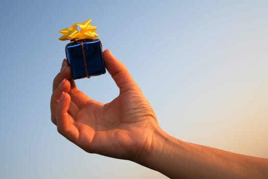 close up shot of blue giftbox in hand