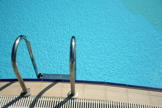 blue swimming pool in summer