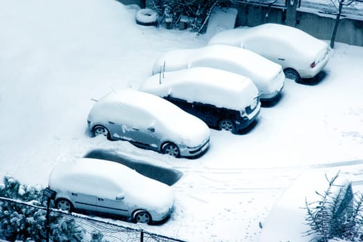 cars covered with snow in winter time