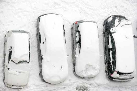 cars covered with snow in winter time