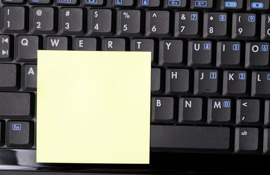 Blank Note On Black Laptop
