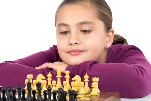 Attractive little girl playing chess