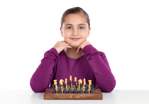 Attractive little girl playing chess