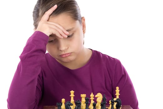 Worried little girl playing chess
