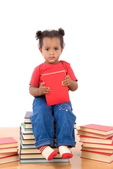 Baby reading sitting on a pile of books