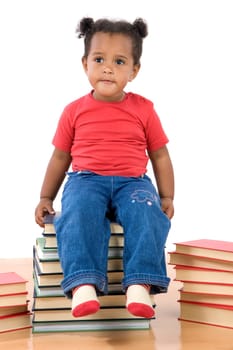 Baby sitting on a pile of books